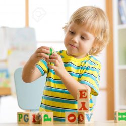 child playing with block toys and learning letters